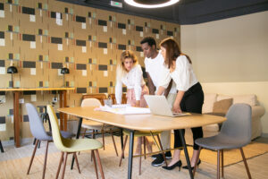 content multiethnic designers standing and looking at draft