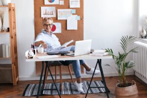 charming lady blue outfit sitting office enjoying coffee min